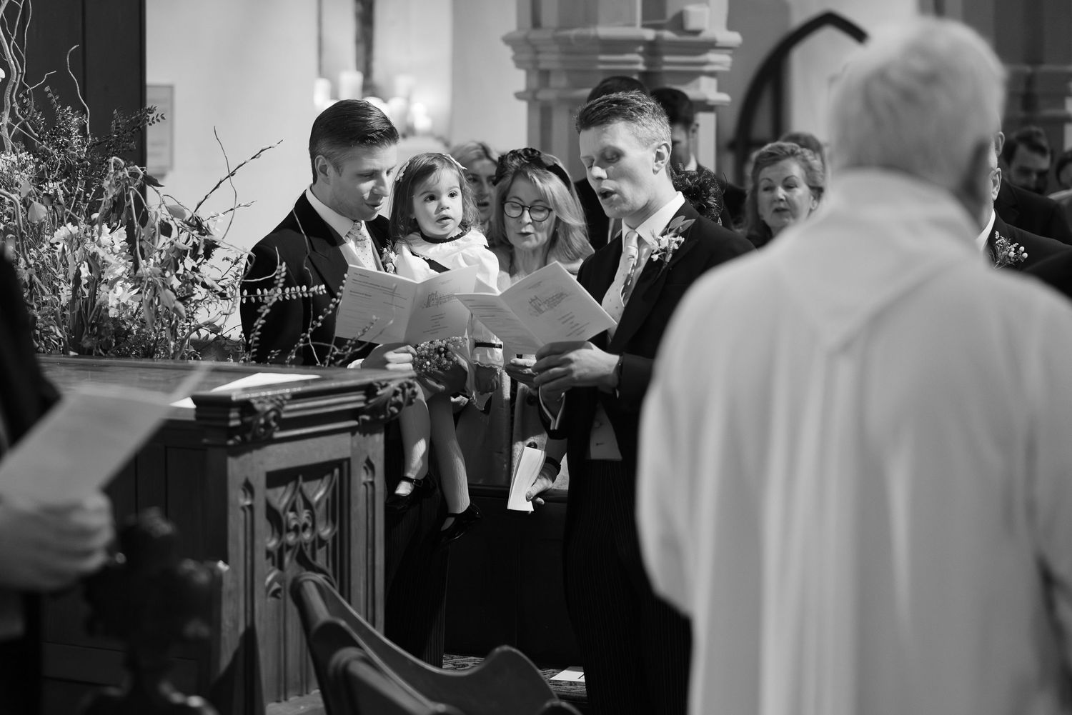 Wedding guests and attendees interacting during a joyful church ceremony.