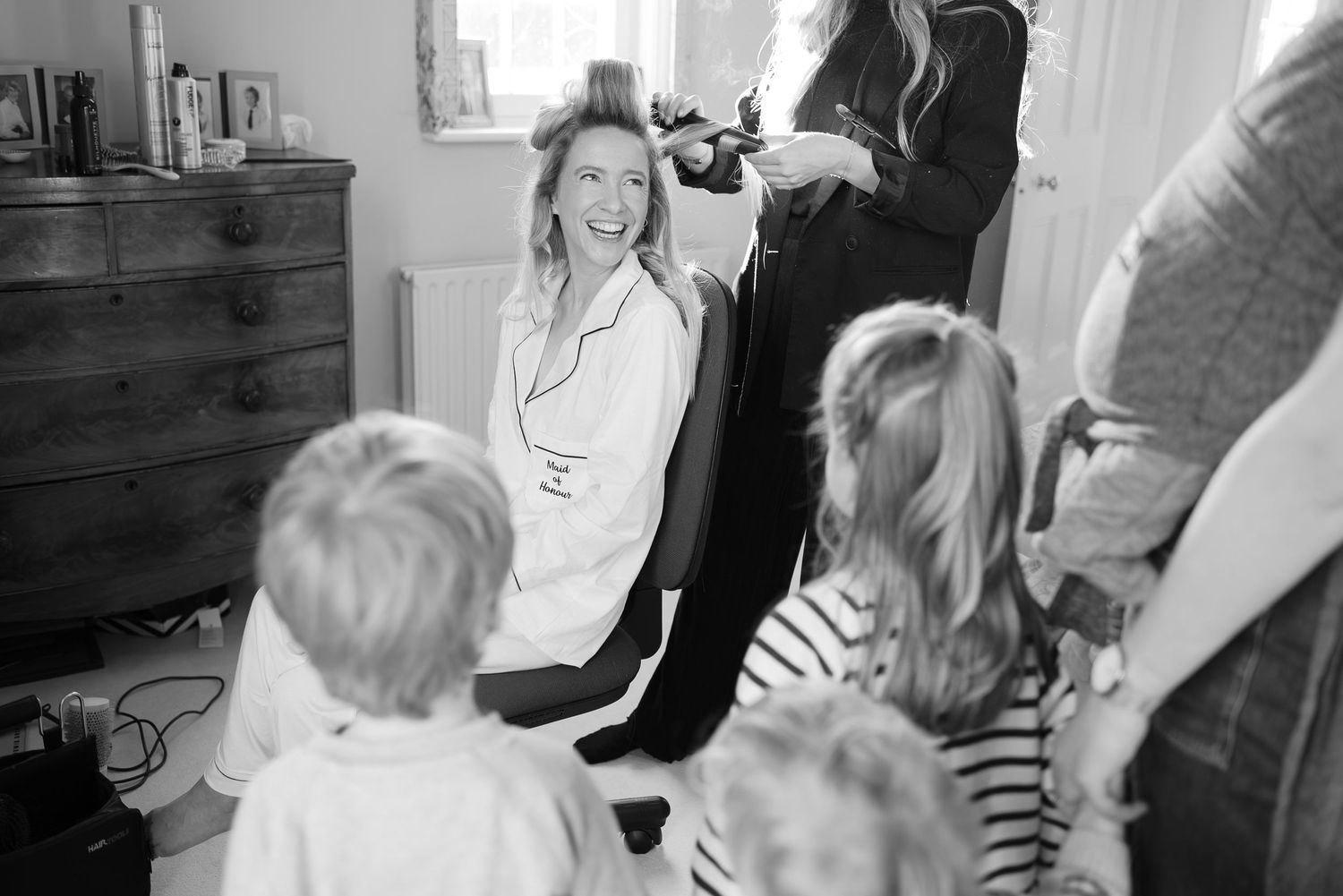 A sequence of black and white photographs showing children and adults interacting during a social gathering.