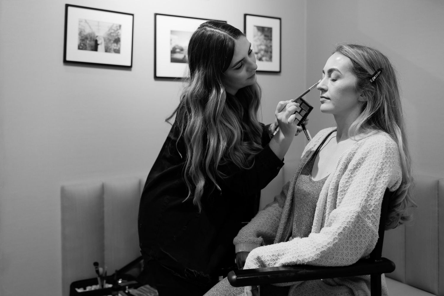 Behind the scenes preparation with makeup application in a quiet room.