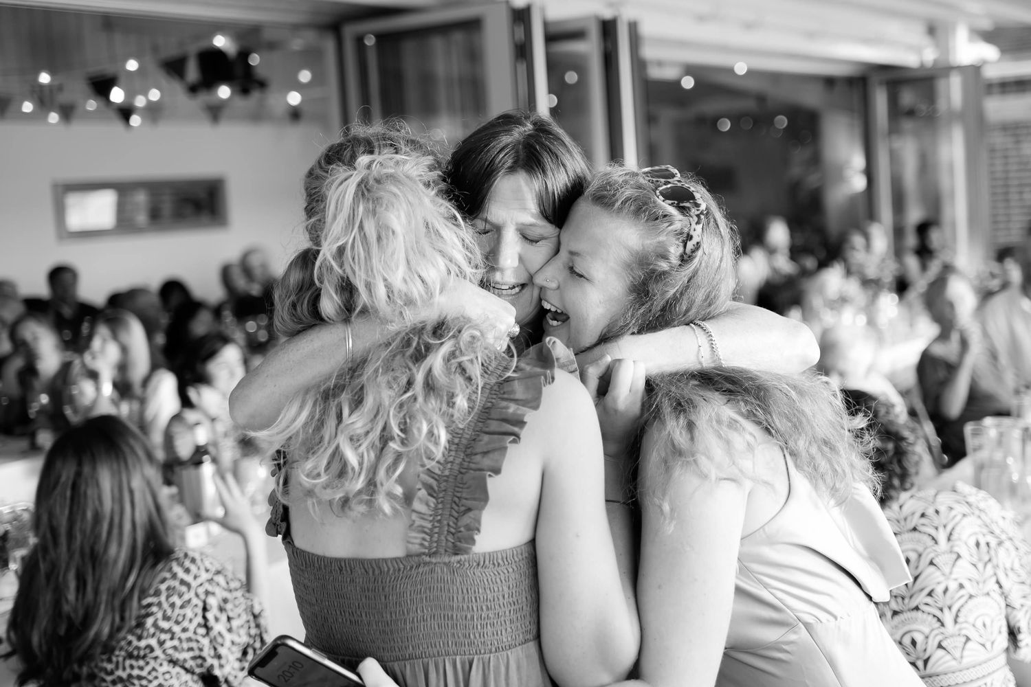 Emotional group embrace at a formal celebration event.