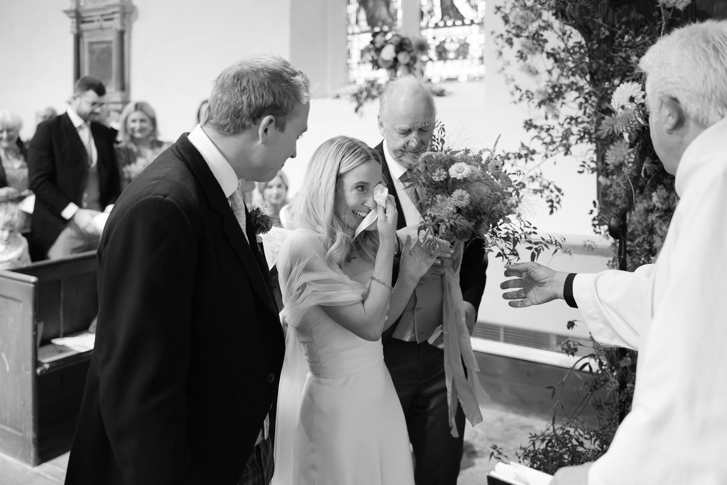 Black and white wedding photos showing intimate moments between couples and guests at an outdoor reception celebration.