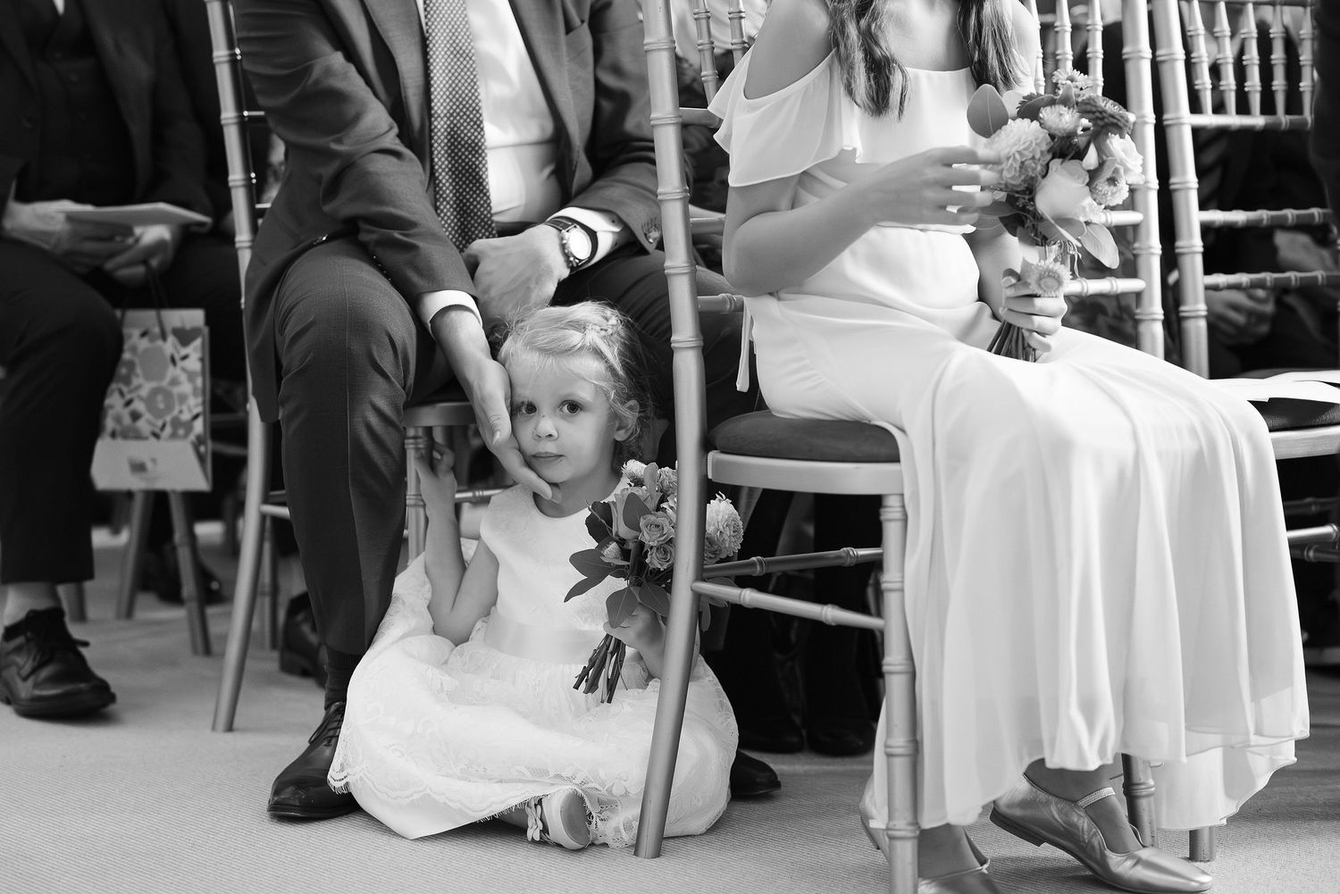 Wedding guests seated at round tables during the reception celebration.