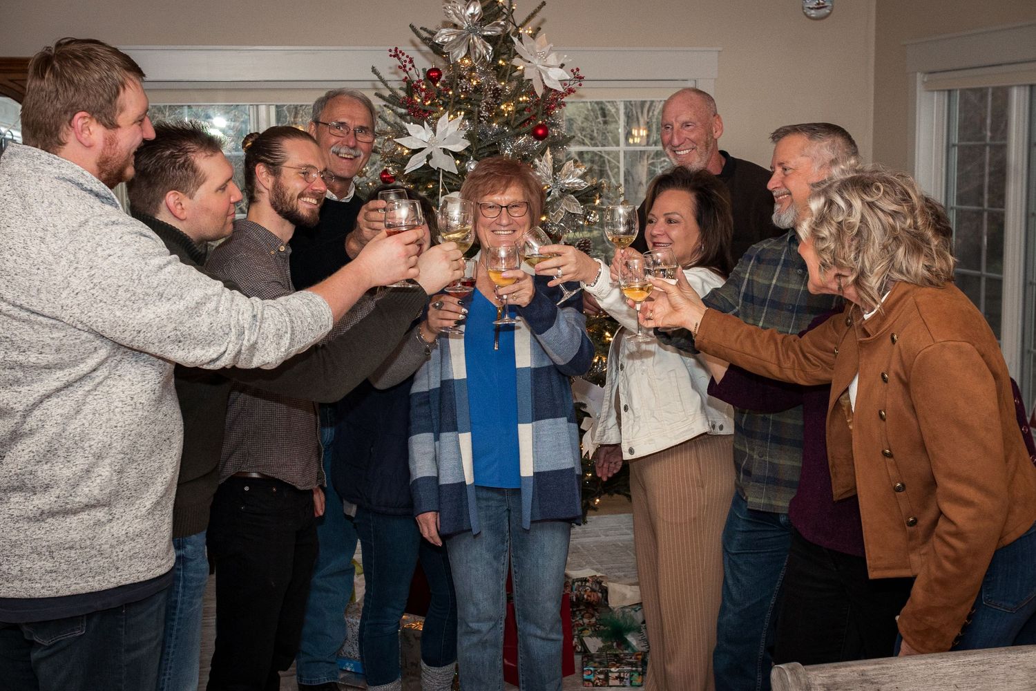 Family session indoors, showing a family making a toast. JDalbey Photography — family portraits in Champaign, IL.