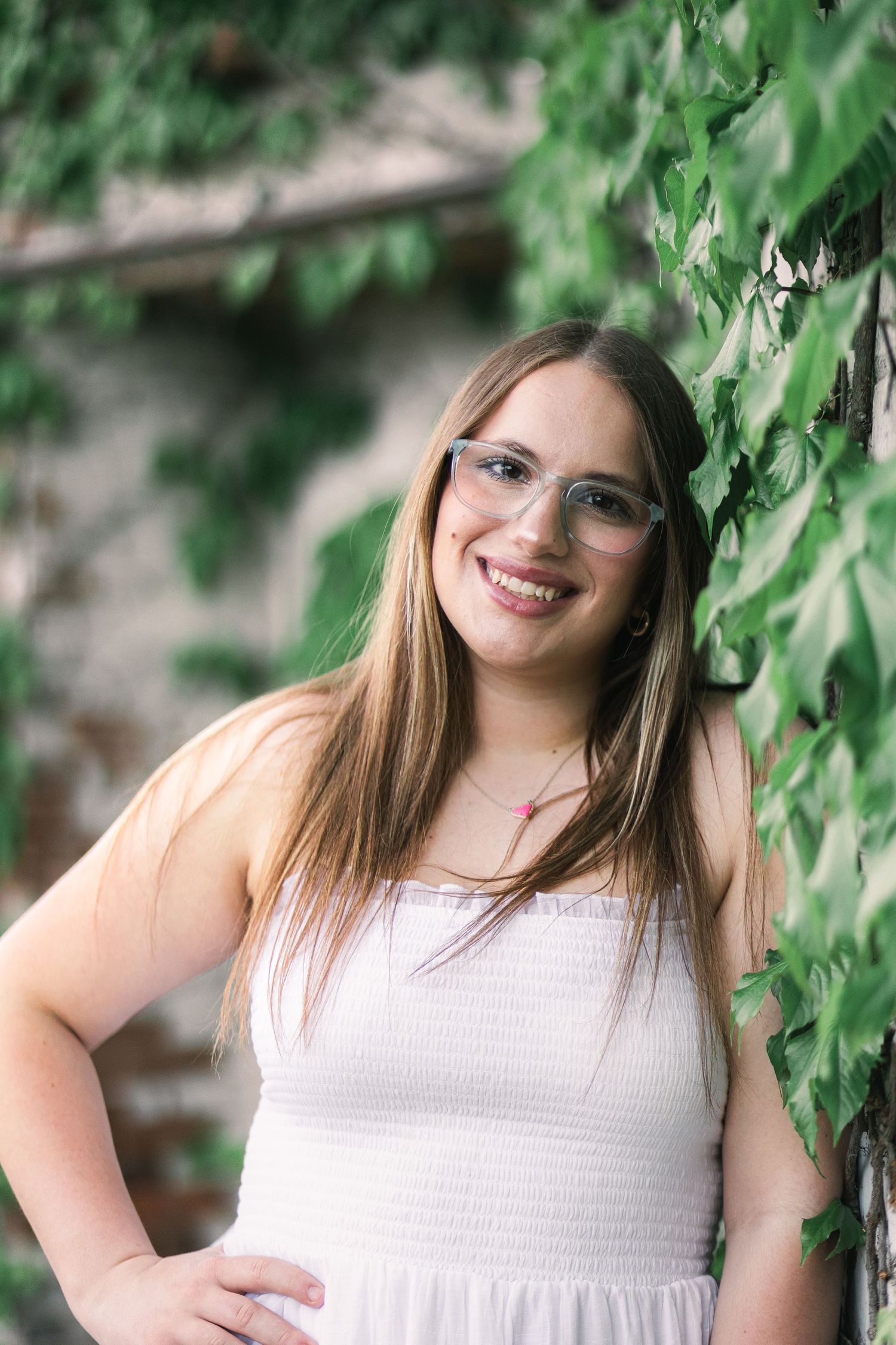 Senior portrait in downtown Champaign, showing girl leaning against wall with vines. JDalbey Photography — Champaign IL senior portraits.