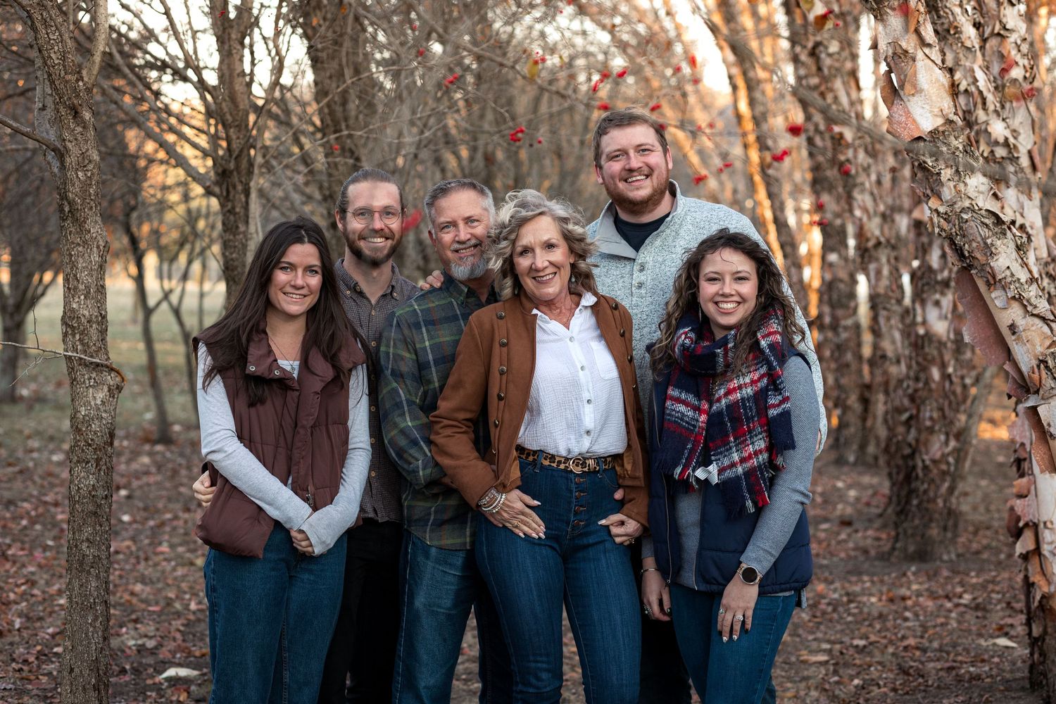 Family session in the woods, showing a family of six smiling together. JDalbey Photography — family portraits in Champaign, IL.