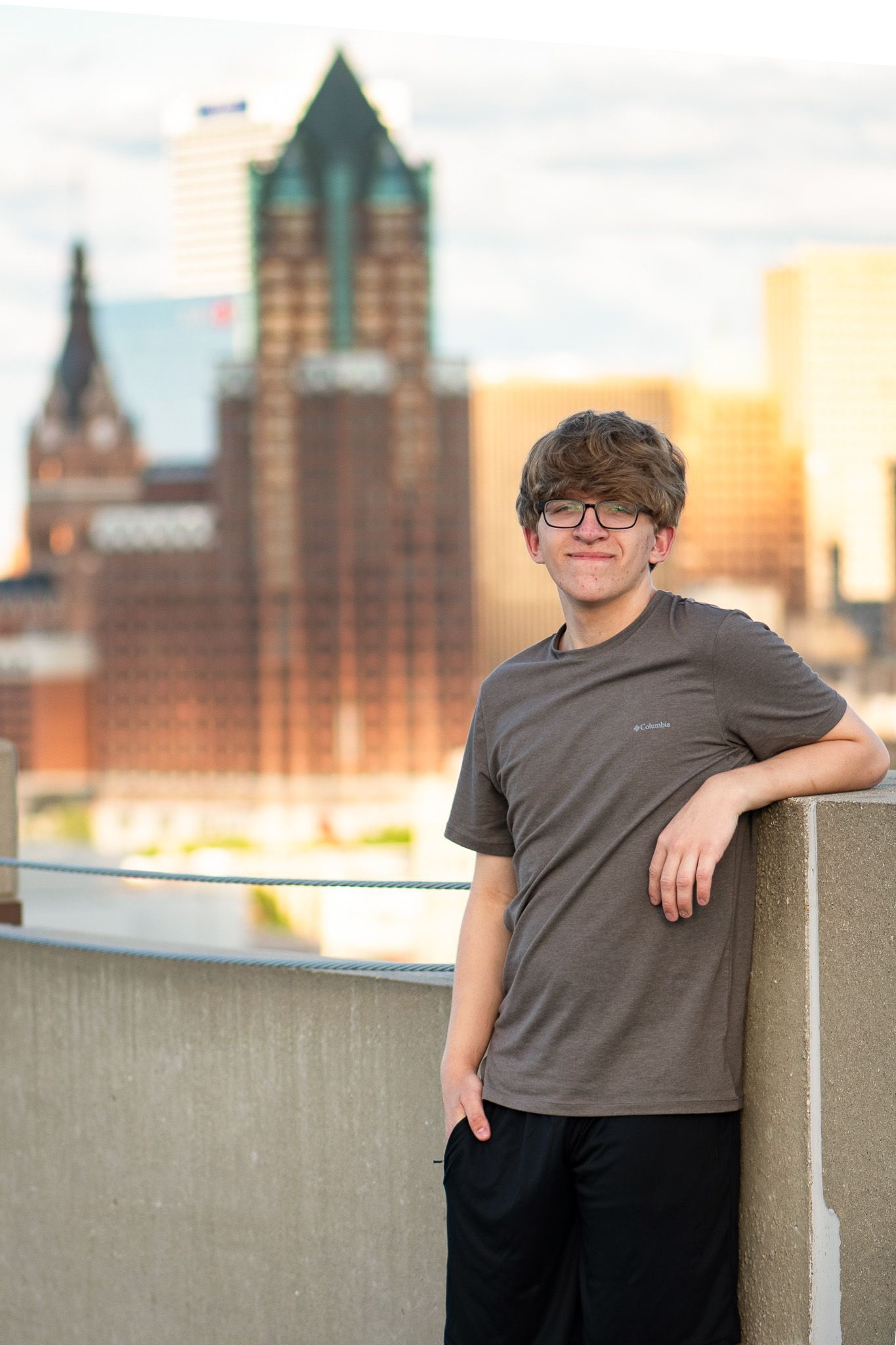 Urban rooftop portrait with Milwaukee city skyline for Signature Senior high school portrait session with Simply Junique.