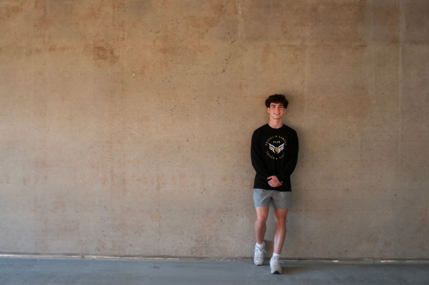 A series of minimalist poses against a plain concrete wall. Franklin High School Senior Portrait Session - Game Day to Grad Day