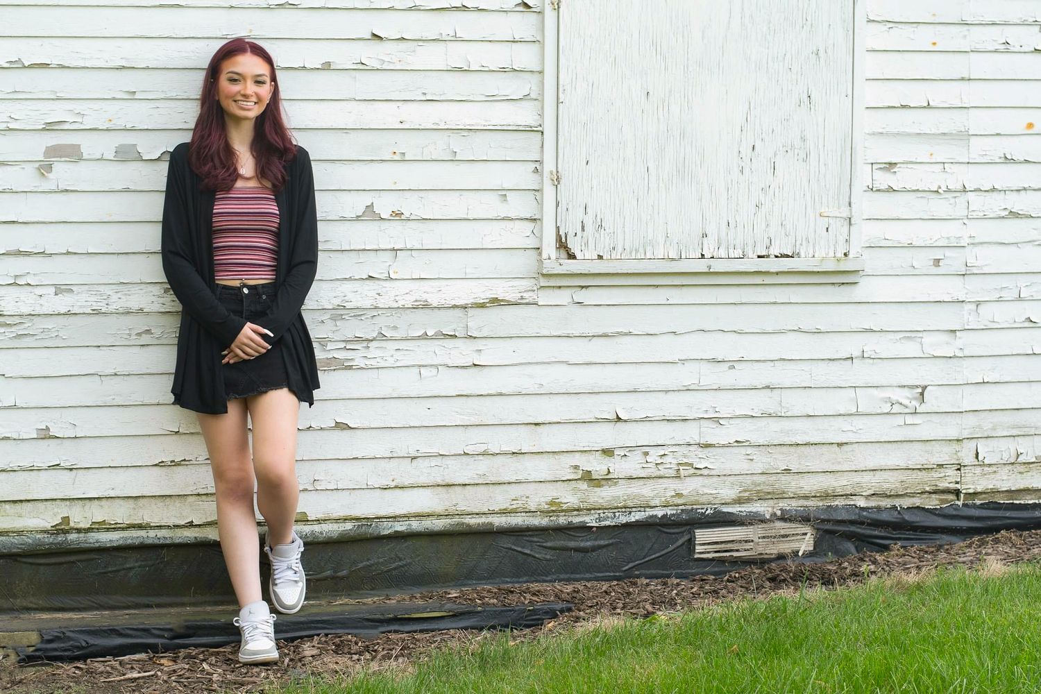 Portrait session against a white wooden siding background.