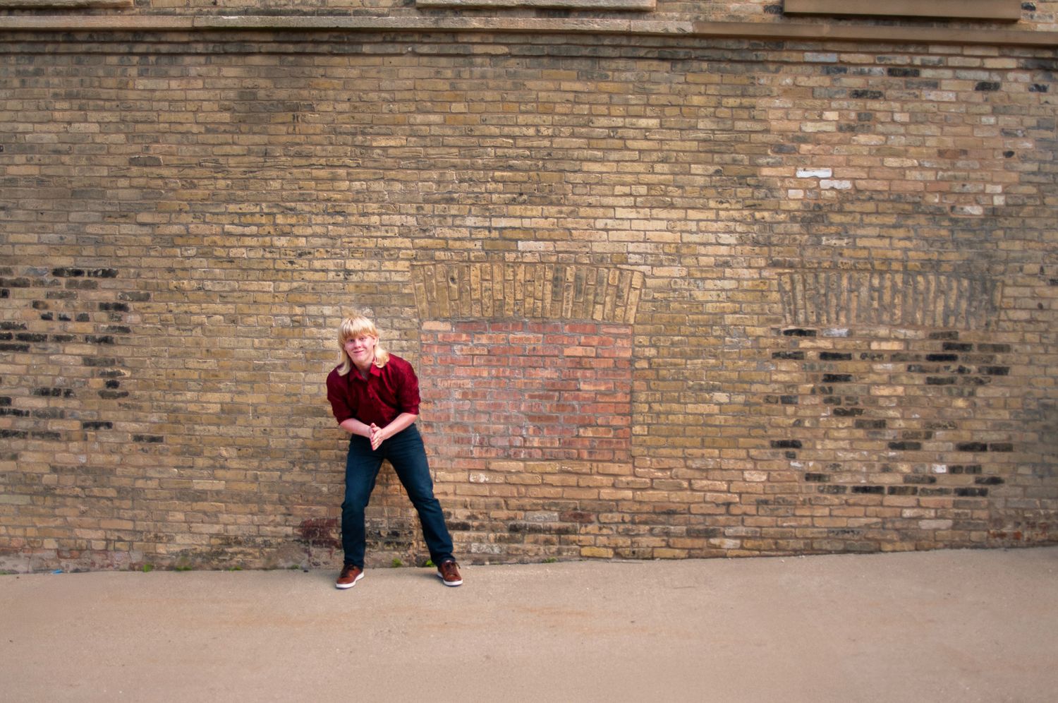 Long brick wall background with rustic textures and shadows.