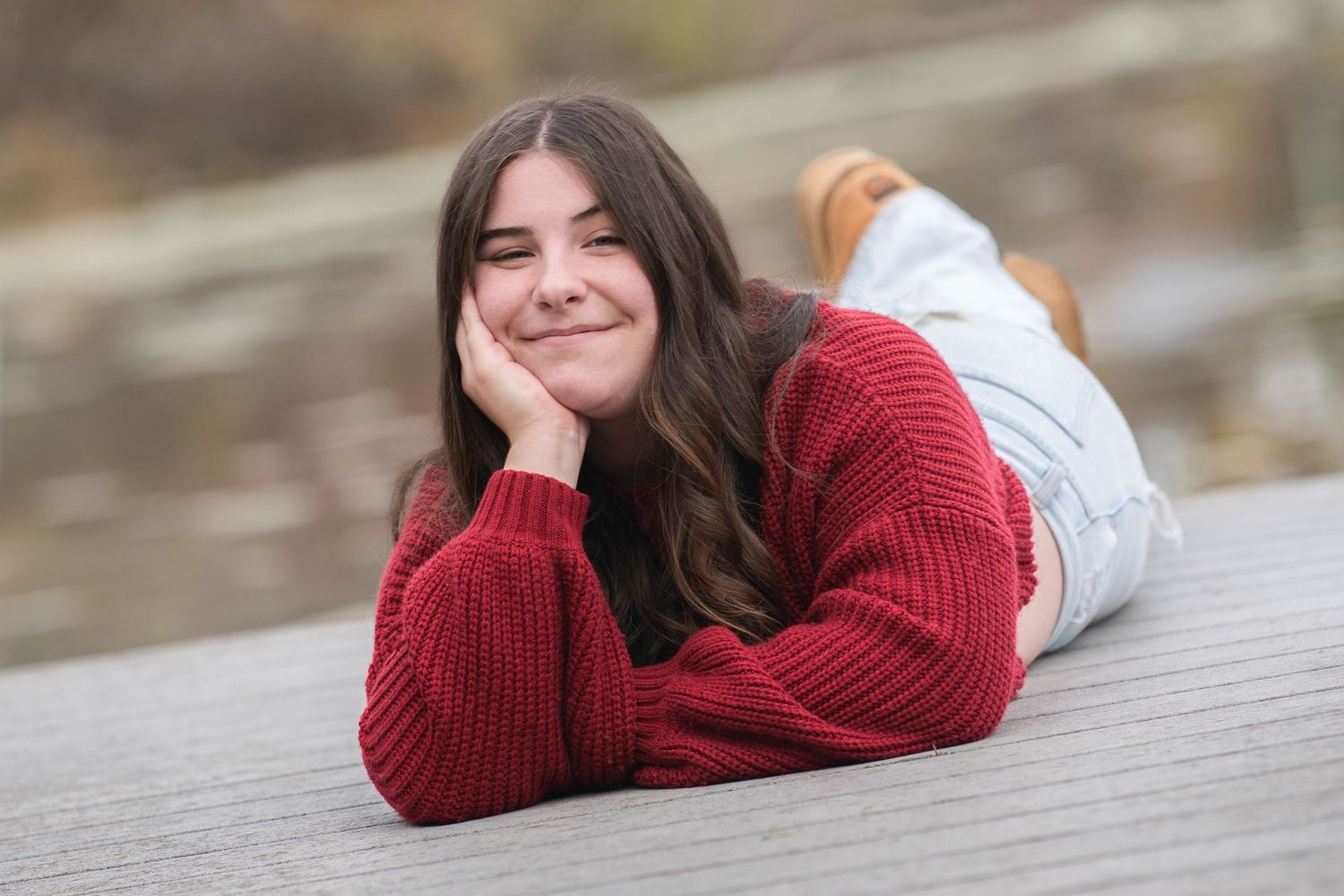 High school senior portrait session showing casual poses on a wooden deck at Whitnall Park  with Simply Junique Senior Portrait Experiences