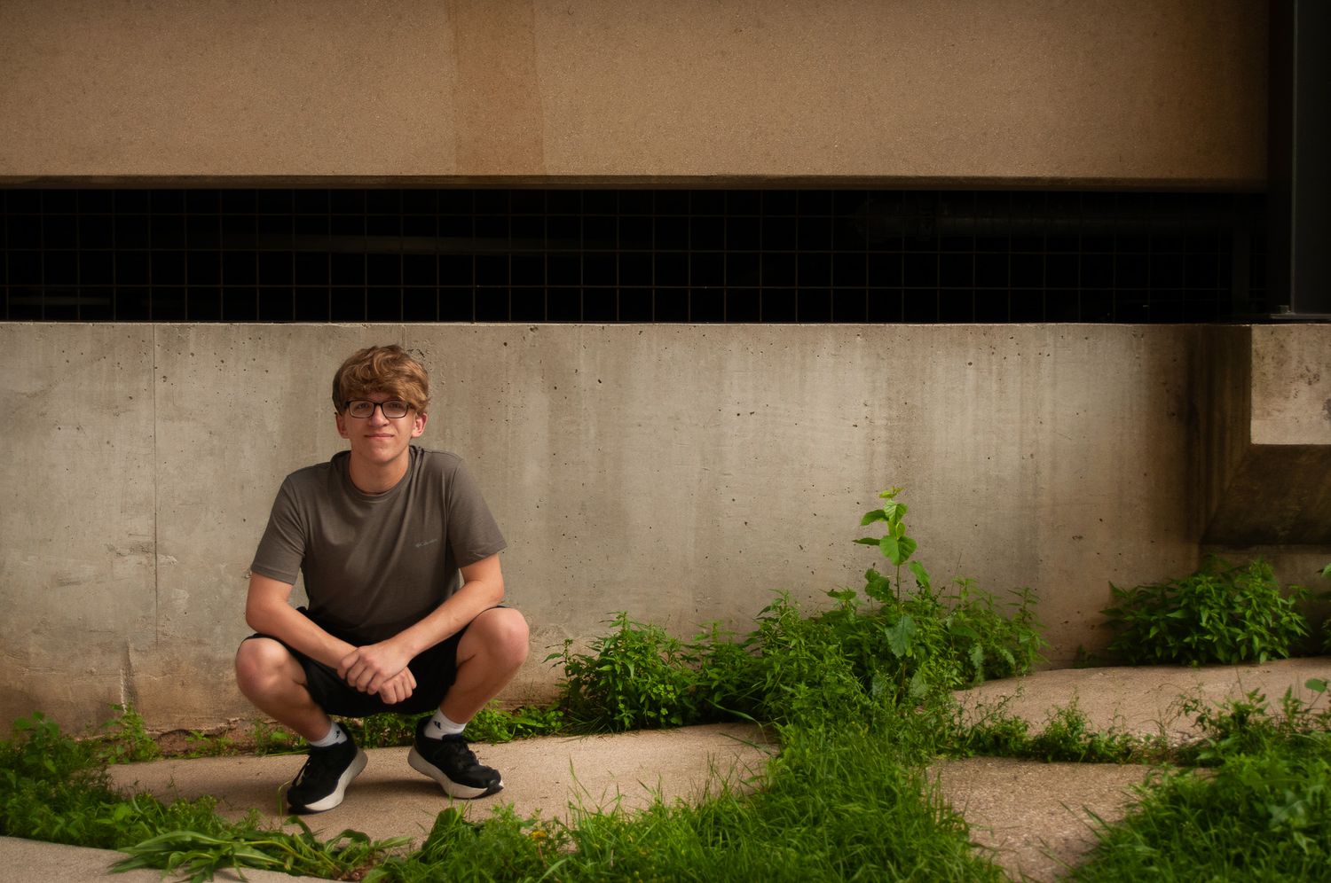 Collection of portrait shots on a concrete wall with natural lighting.