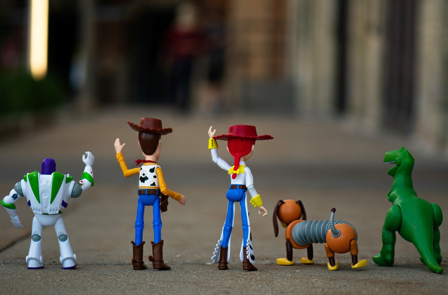 Toy characters lined up on a surface showing a sequential progression from left to right.