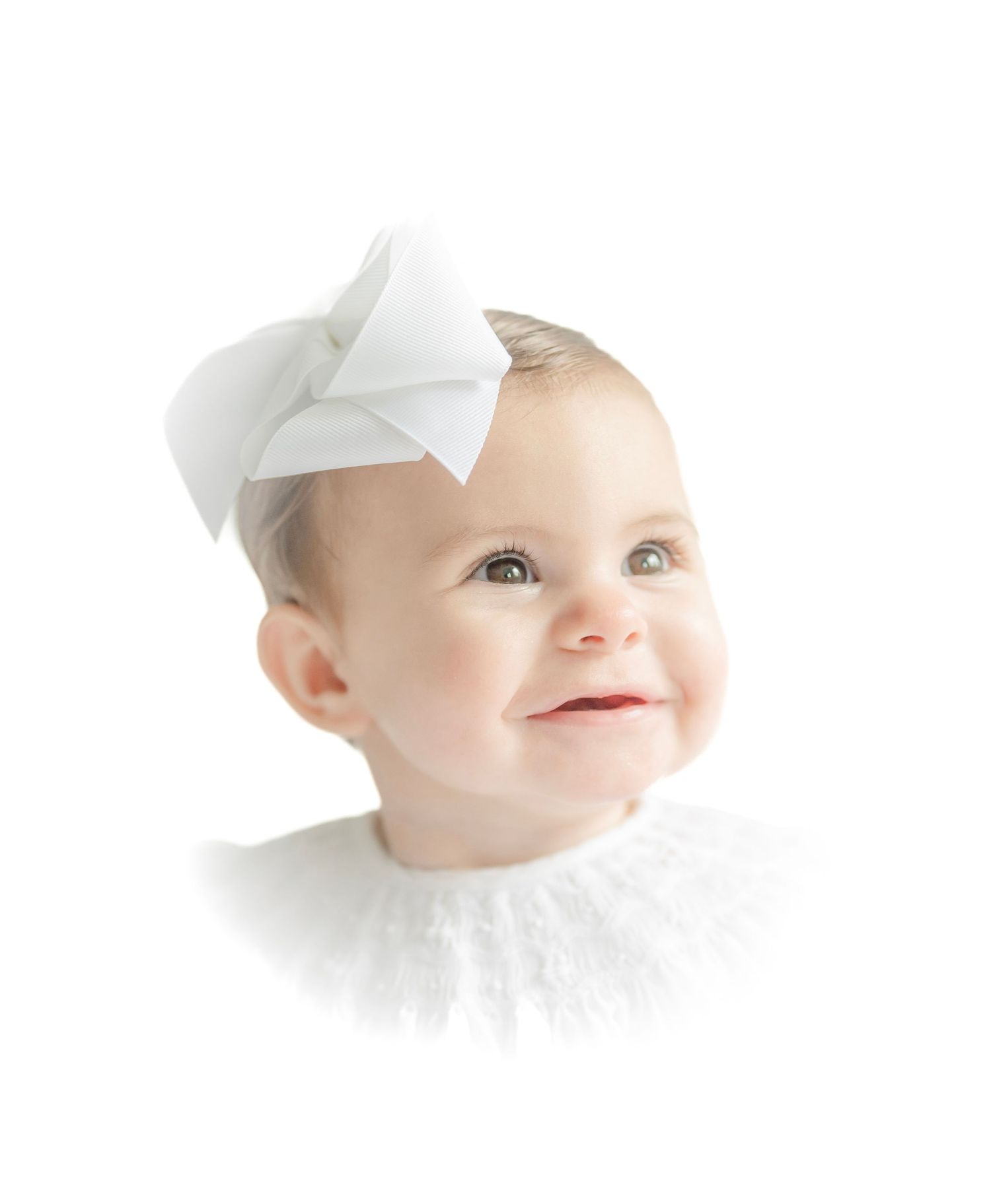 Artistic close-up baby portraits with white bow headband against light background.