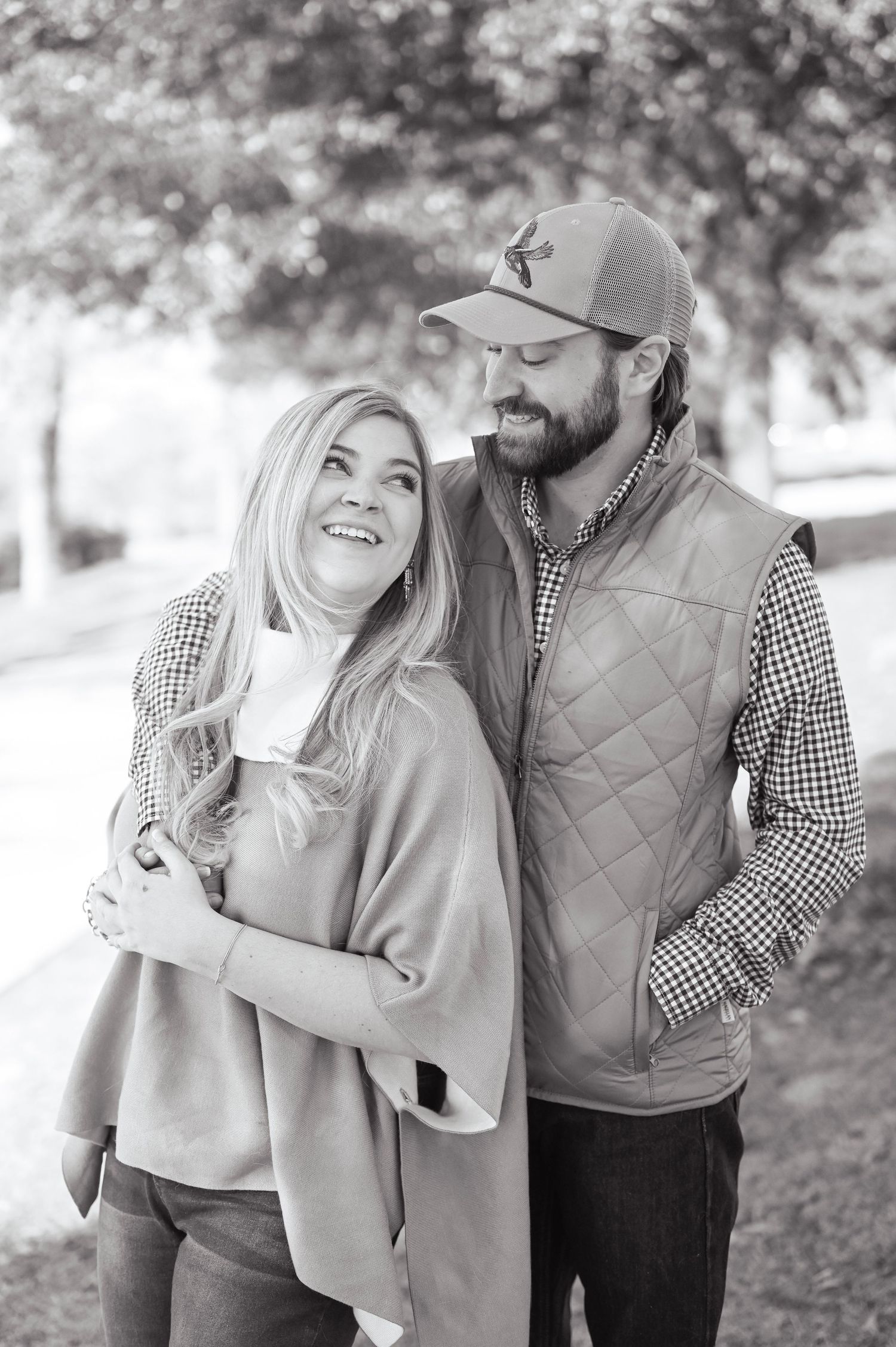 Couple in casual autumn wear sharing joyful moments together outdoors in black and white.