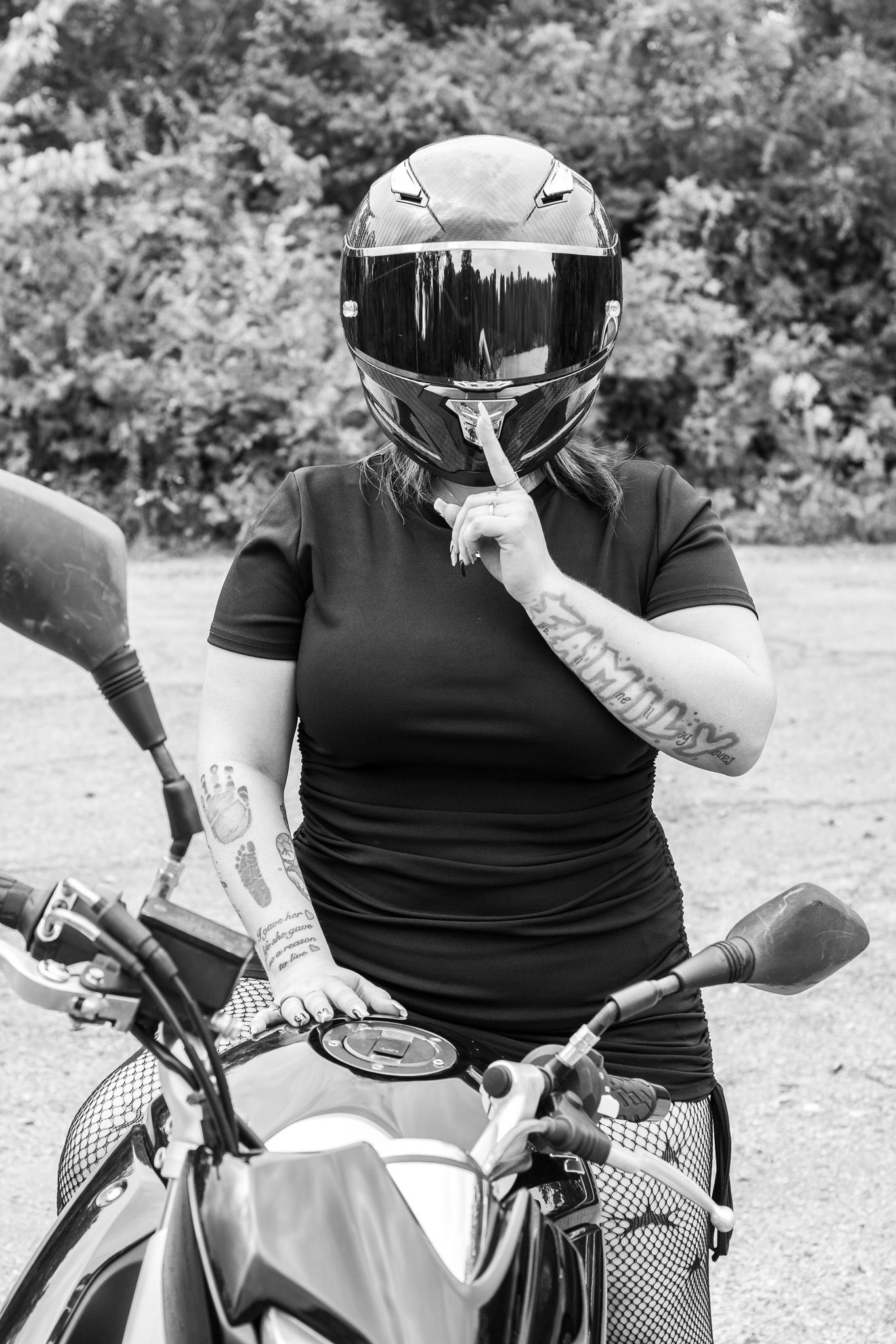 A series of black and white photos showing a motorcyclist adjusting and putting on protective gear.