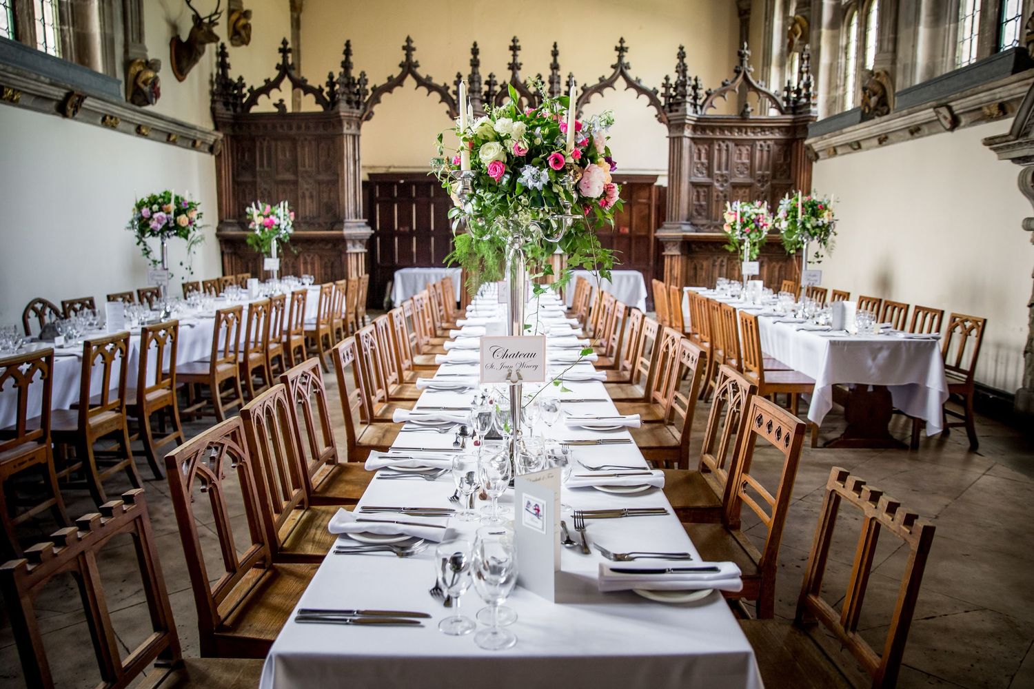 Banquet style table set up in the dining room at Milton Abbey school for a wedding breakfast celebration