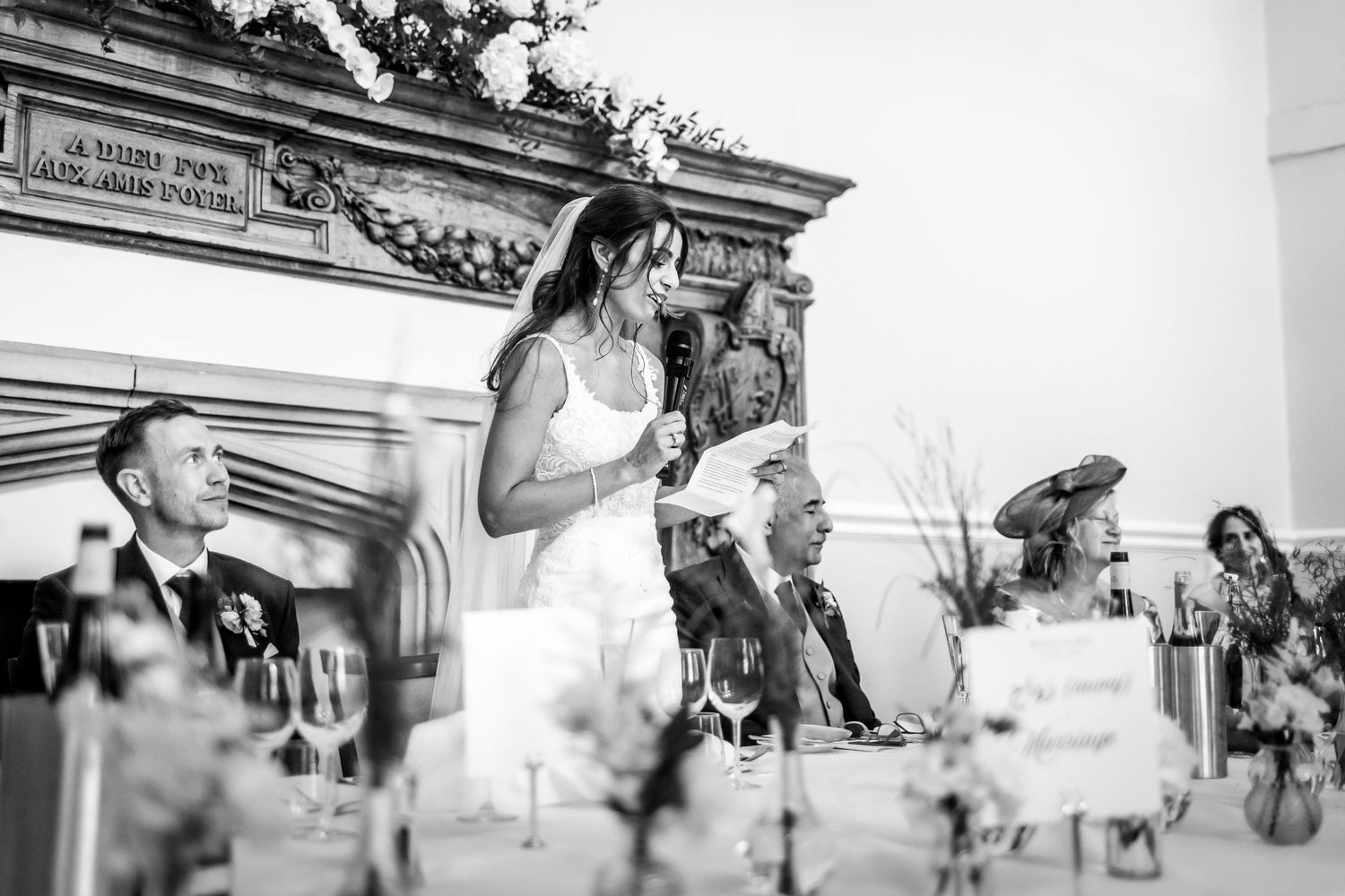 Elegant outdoor wedding reception scene with decorative architectural elements in the background.