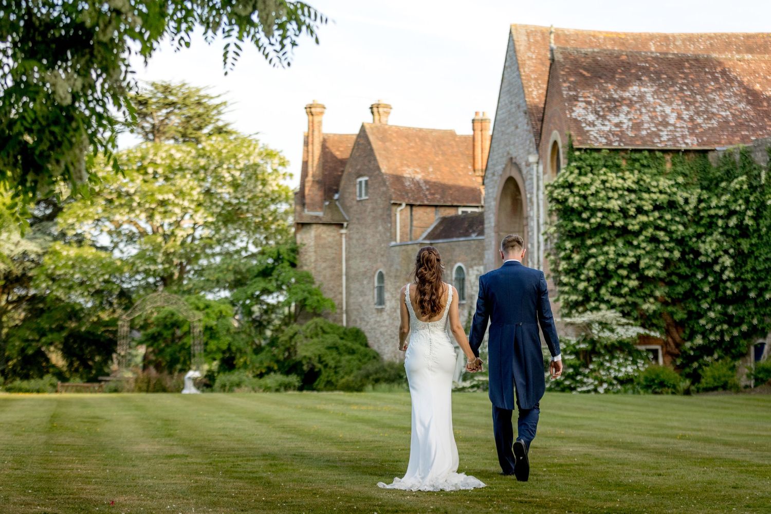 Wedding venue exterior featuring historic stone architecture and manicured gardens.
