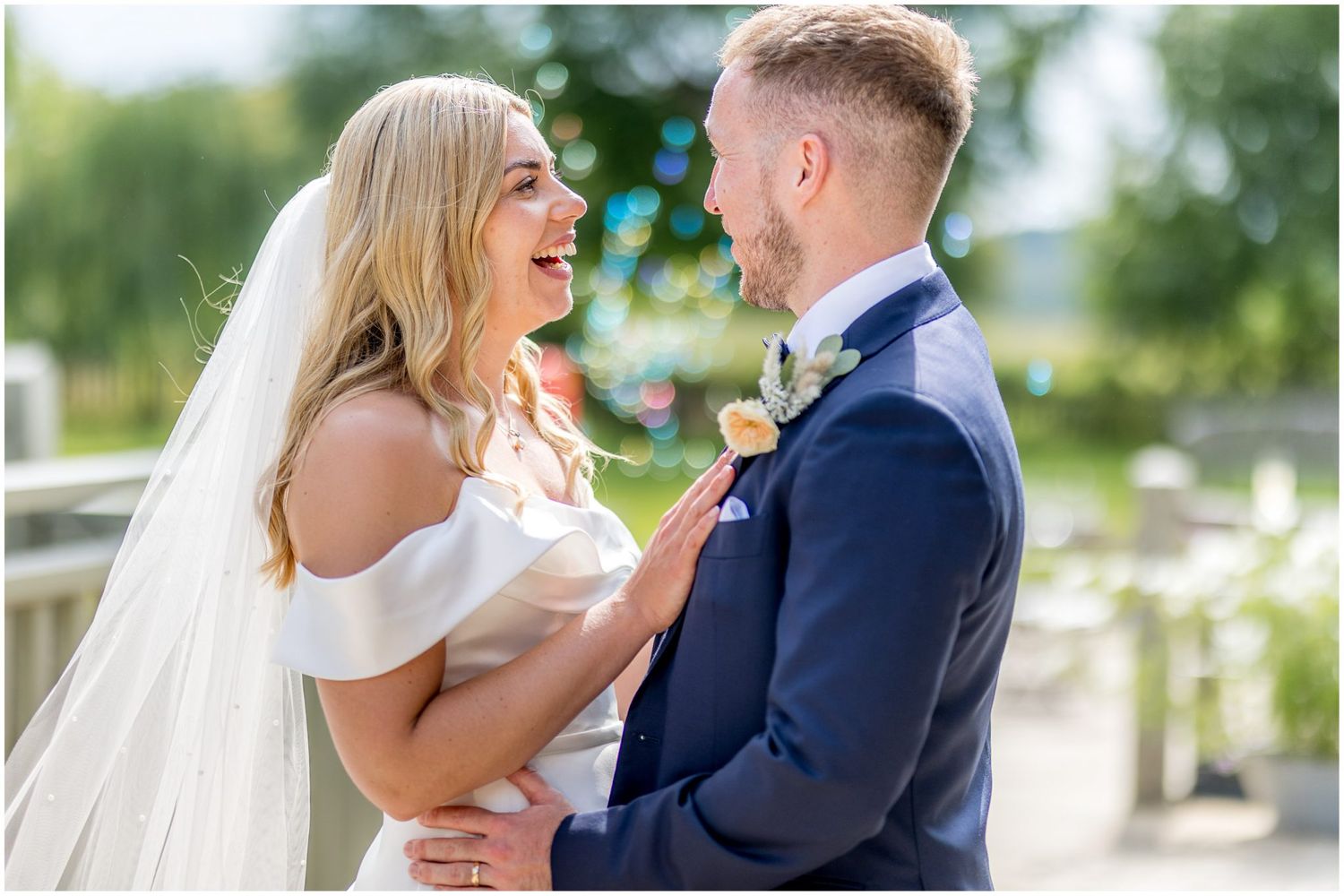 Candid moments between couple show genuine laughter and joy during outdoor wedding portraits.
