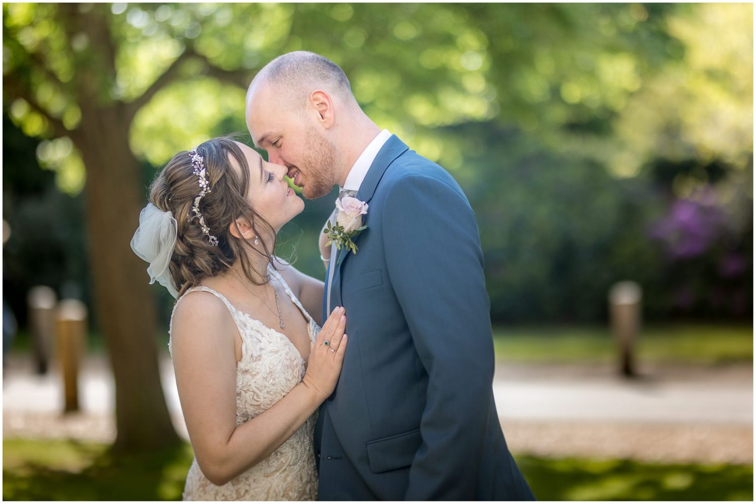 Intimate wedding couple portraits captured in a sunlit garden setting.