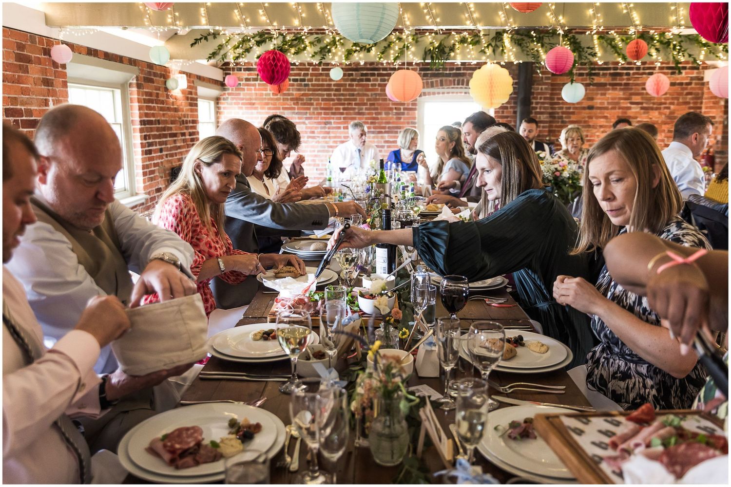 Guests sharing food platters during the wedding breakfast at Sopley Mill in the New Forest