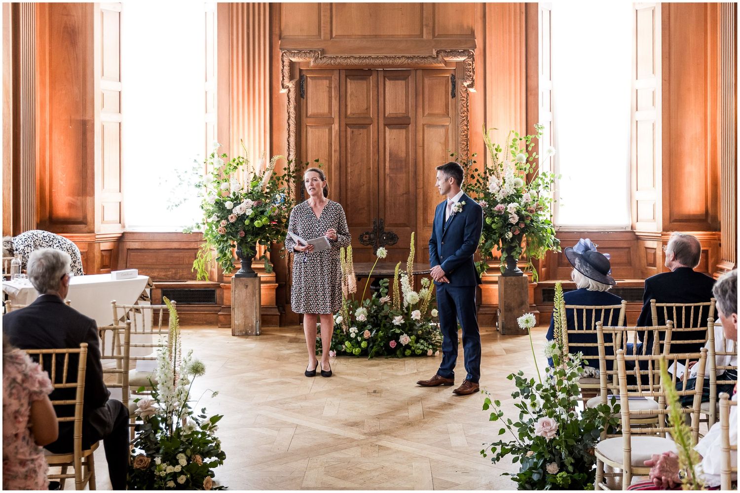The groom stands with the registrar at the end of the aisle for a Walhampton School wedding, awaiting the arrival of the bride.