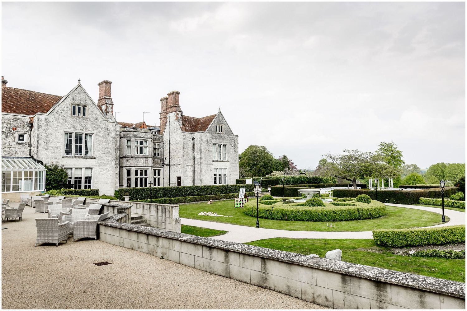 Exterior views of a grand stone manor house with manicured gardens and elegant architecture.