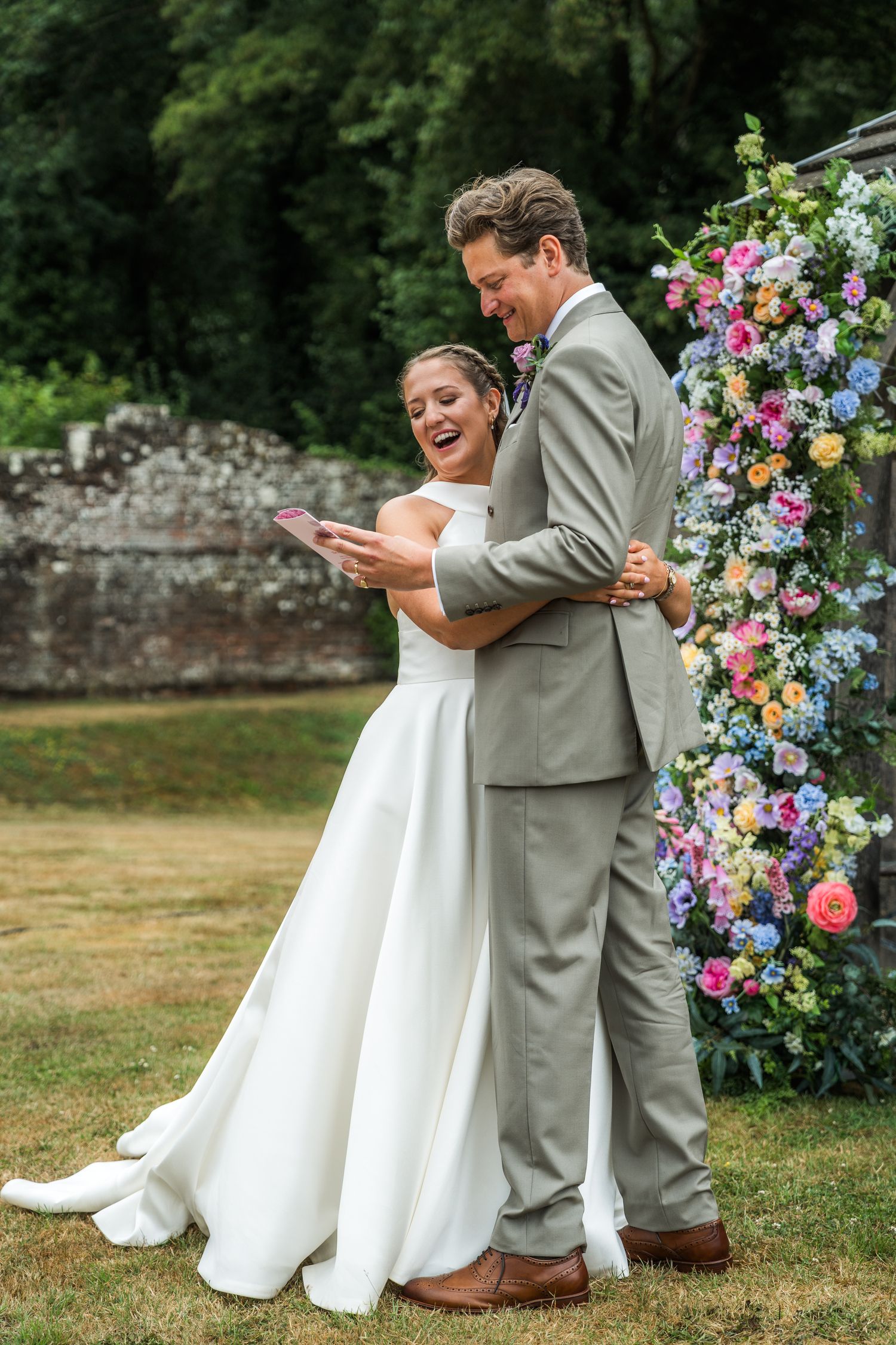 Candid moments captured during a garden wedding ceremony with colorful floral decorations.