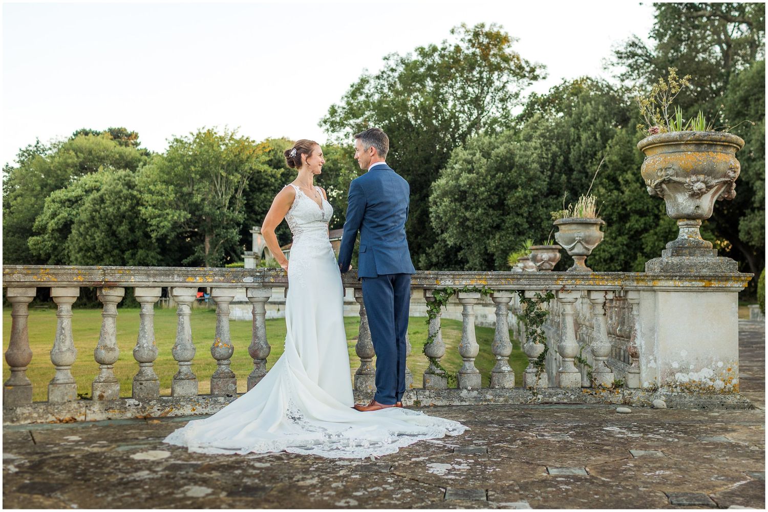 The wedding couple on the terrace behind Walhampton School during a golden hour portrait photoshoot