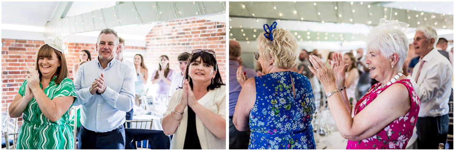 Guests enjoying a lively wedding reception in a rustic brick-walled venue.