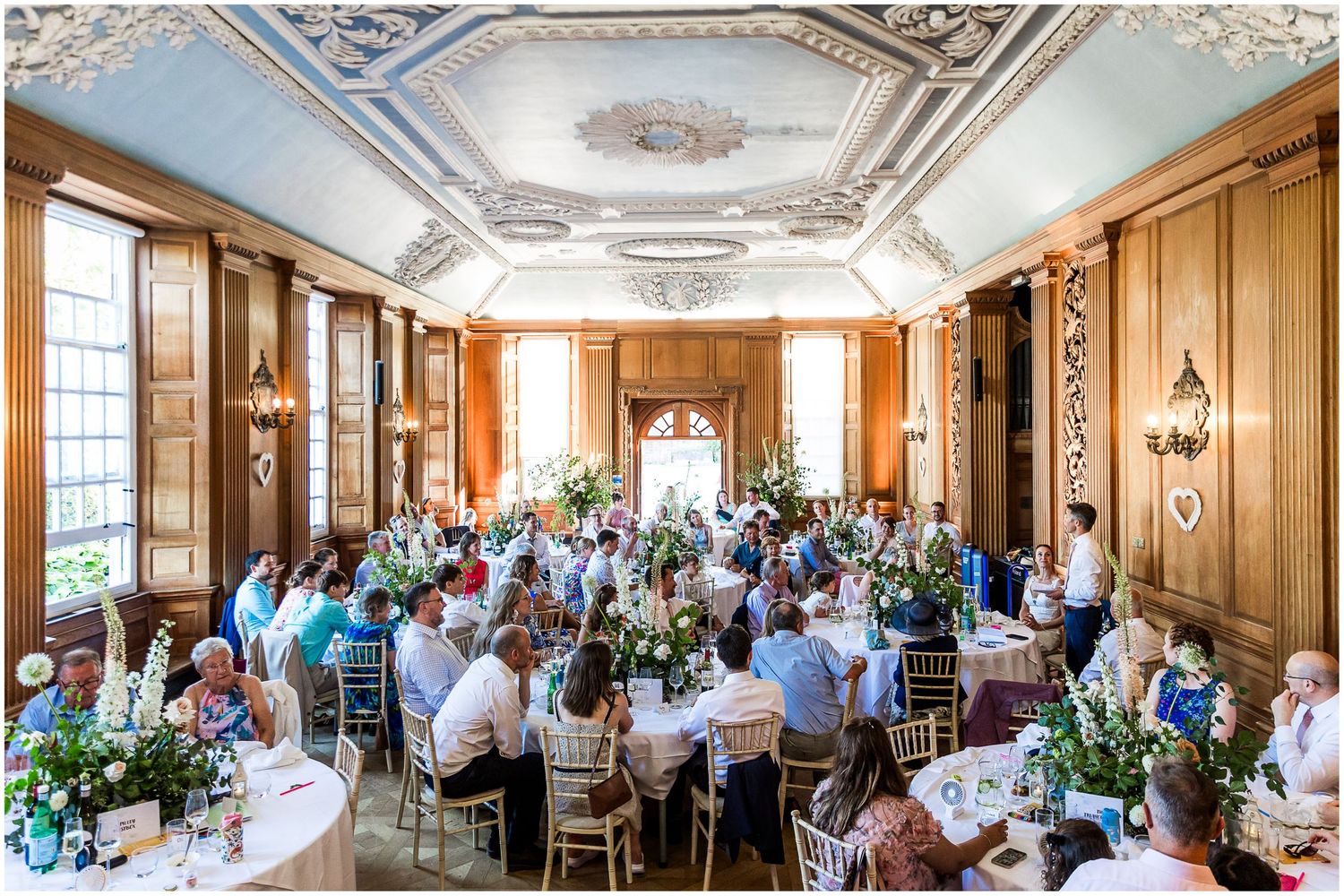 Documentary photography of wedding speeches in the wood-panelled hall at Walhampton School in the New Forest