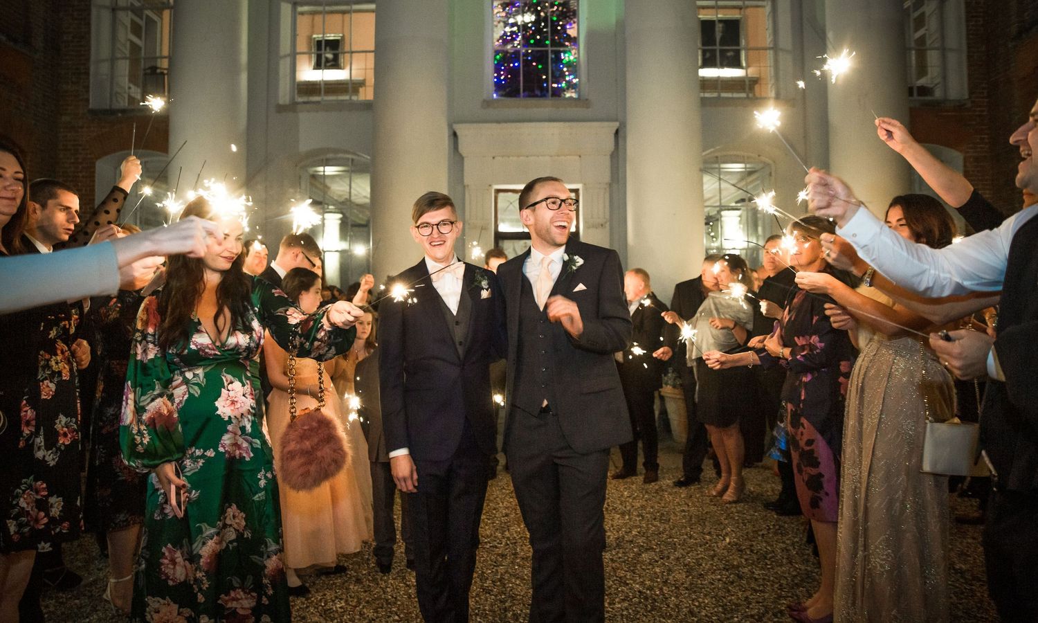 A sparkler exit for a same sex wedding couple outside Avington Park, a stately home venue near Winchester in Hampshire