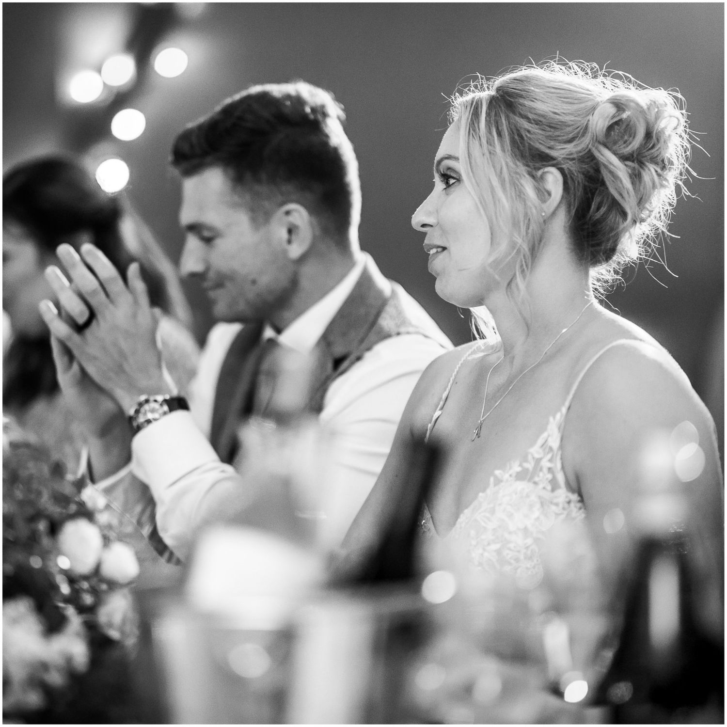 Black and white photo of wedding guests enjoying emotional moments at reception.