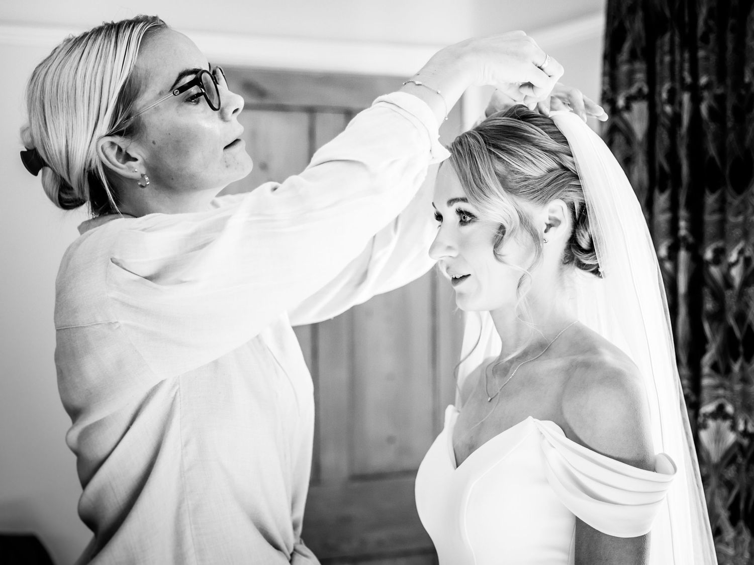 Series of black and white photos showing wedding day hair and makeup preparations.