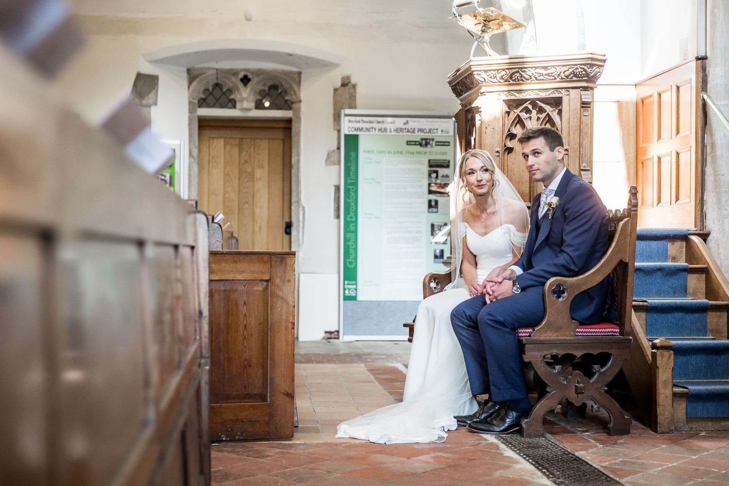 Intimate moment captured in church setting with soft natural lighting.