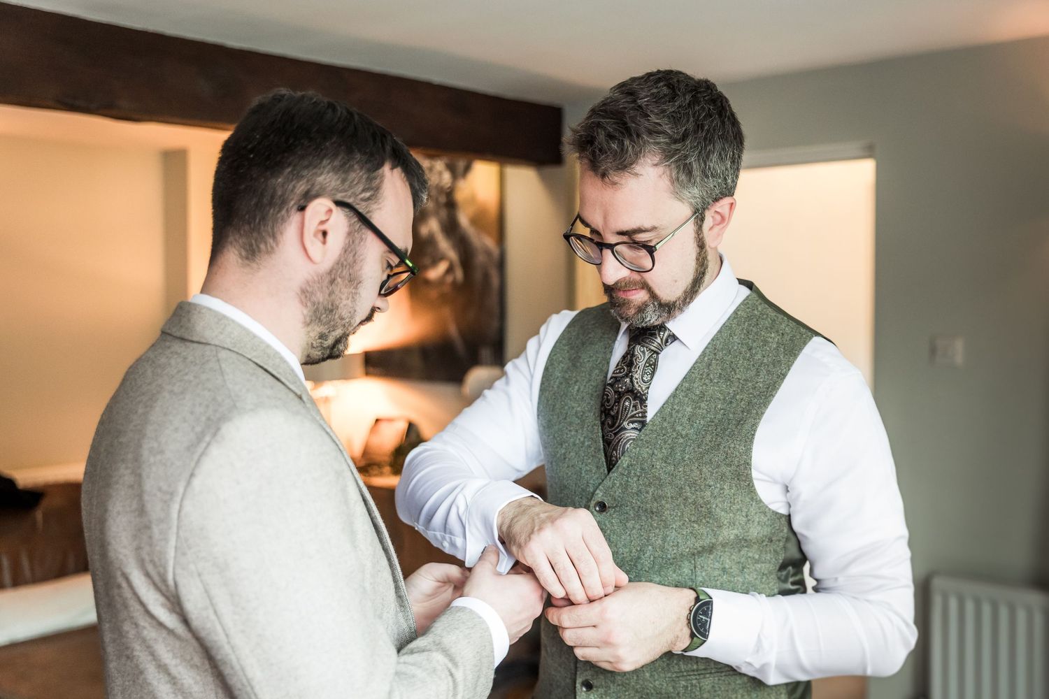 A sequence of photos showing a person being helped into formal attire and adjusting a tie before a special event.