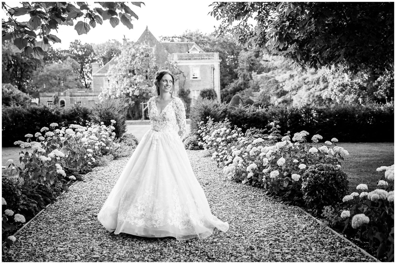 A black and white photo series showing a bride in a flowing wedding gown posing in a lush garden setting.
