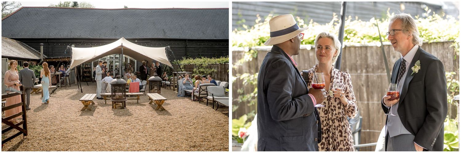 Wedding reception setup at rustic barn venue with guests mingling outdoors.