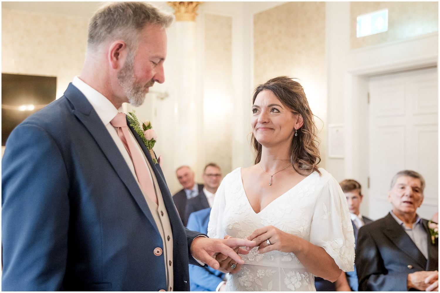 Emotional wedding ceremony moments captured in a bright indoor setting.