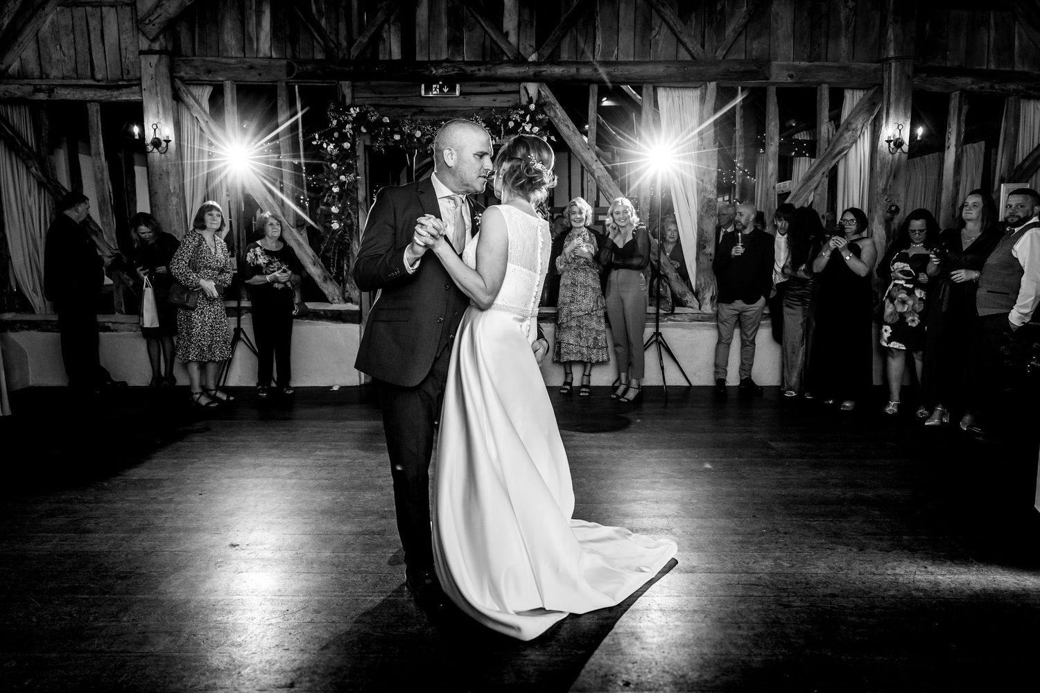 Black and white first dance photograph in the evening party rooms at Clock Barn