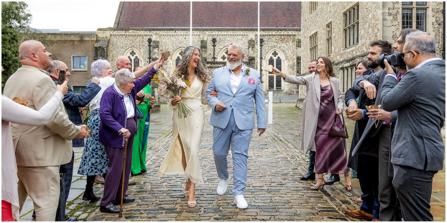 Wedding guests greet the newly married couple with confetti as they exit the Registry Office in Winchester.