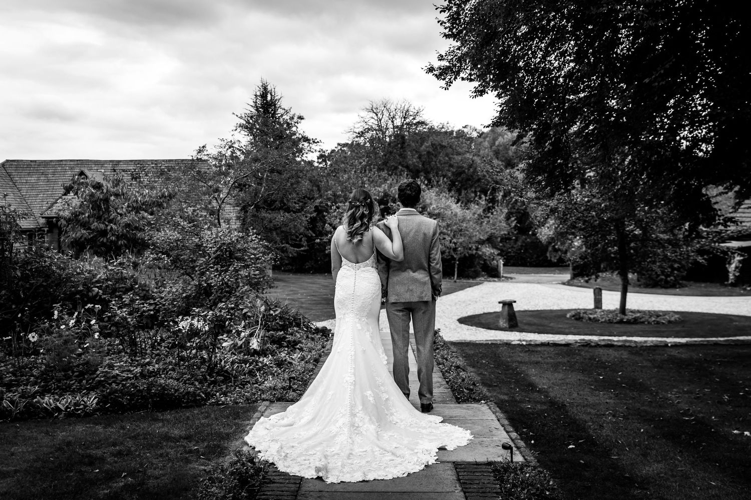 Black and white wedding portrait of a couple at Clock Barn in Hampshire looking across the central courtyard