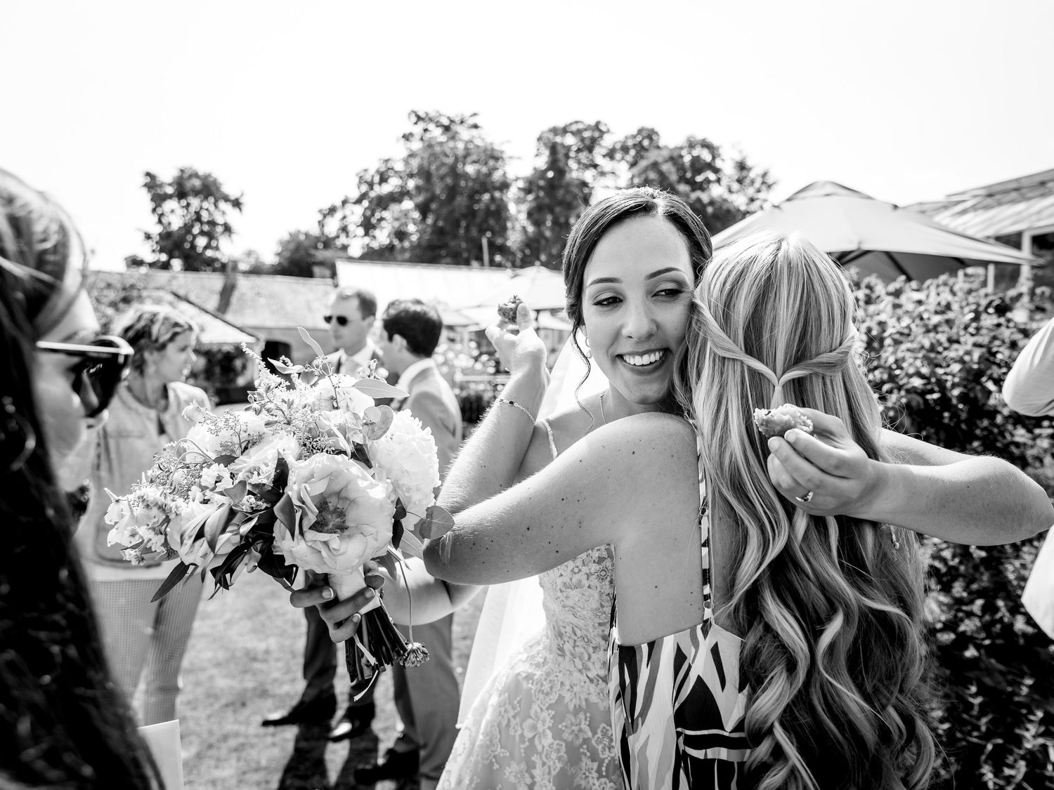 Black and white candid shots of wedding guests mingling at outdoor reception.