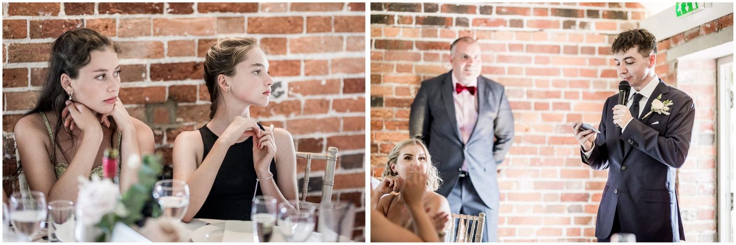 Reception tables decorated with floral centerpieces against exposed brick walls.