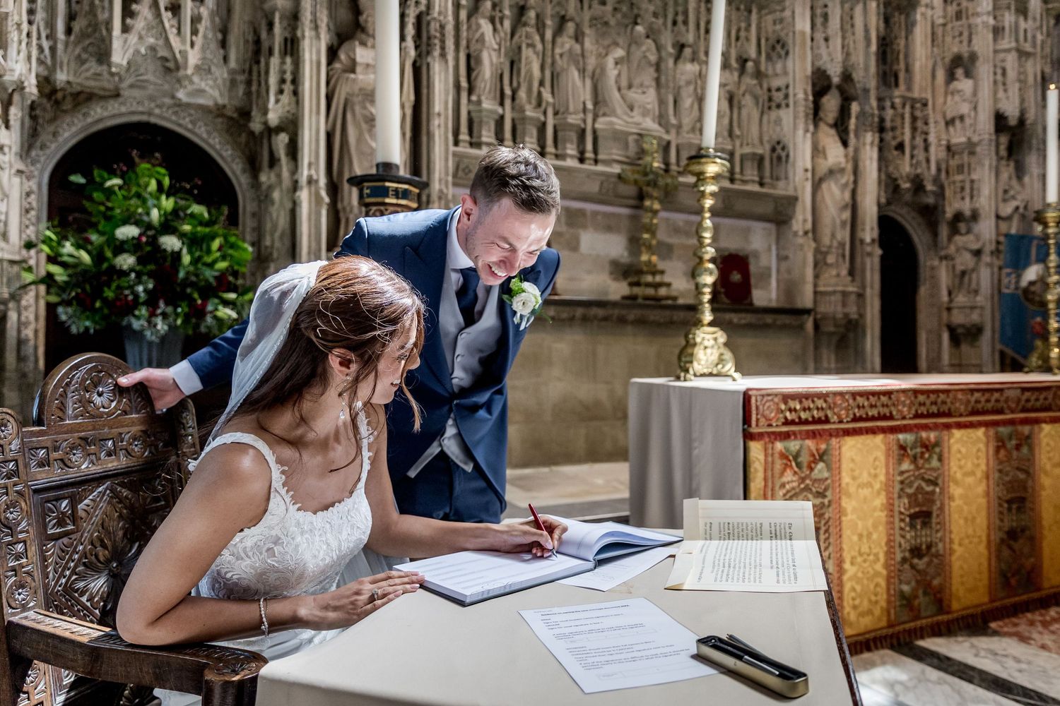 Cathedral wedding ceremony with dramatic architectural elements and natural lighting.