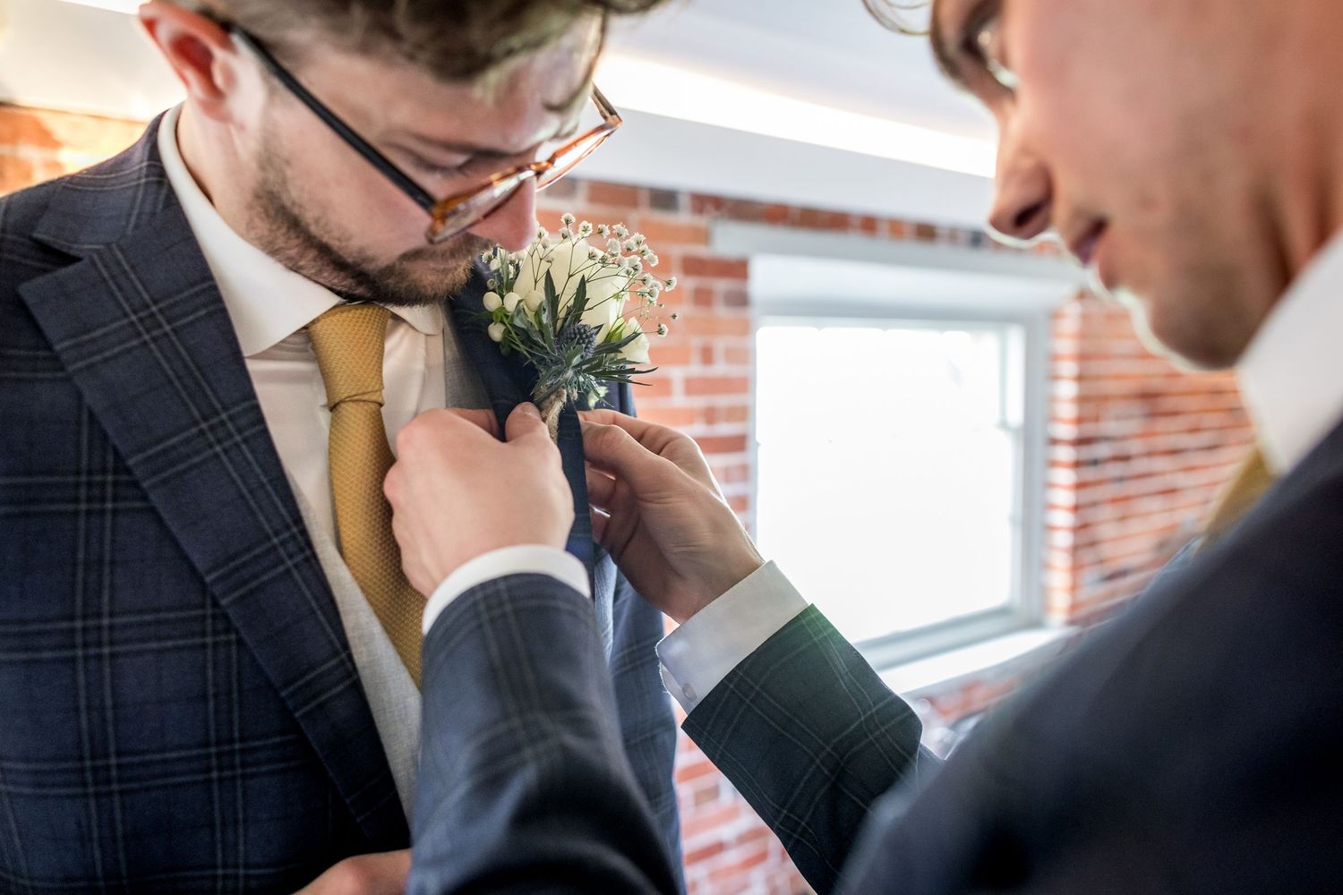 Close-up shot of two people in suits having an emotional exchange.