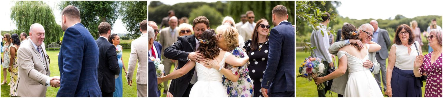 Guests mingling and celebrating outdoors at a summer wedding reception on a sunny day.