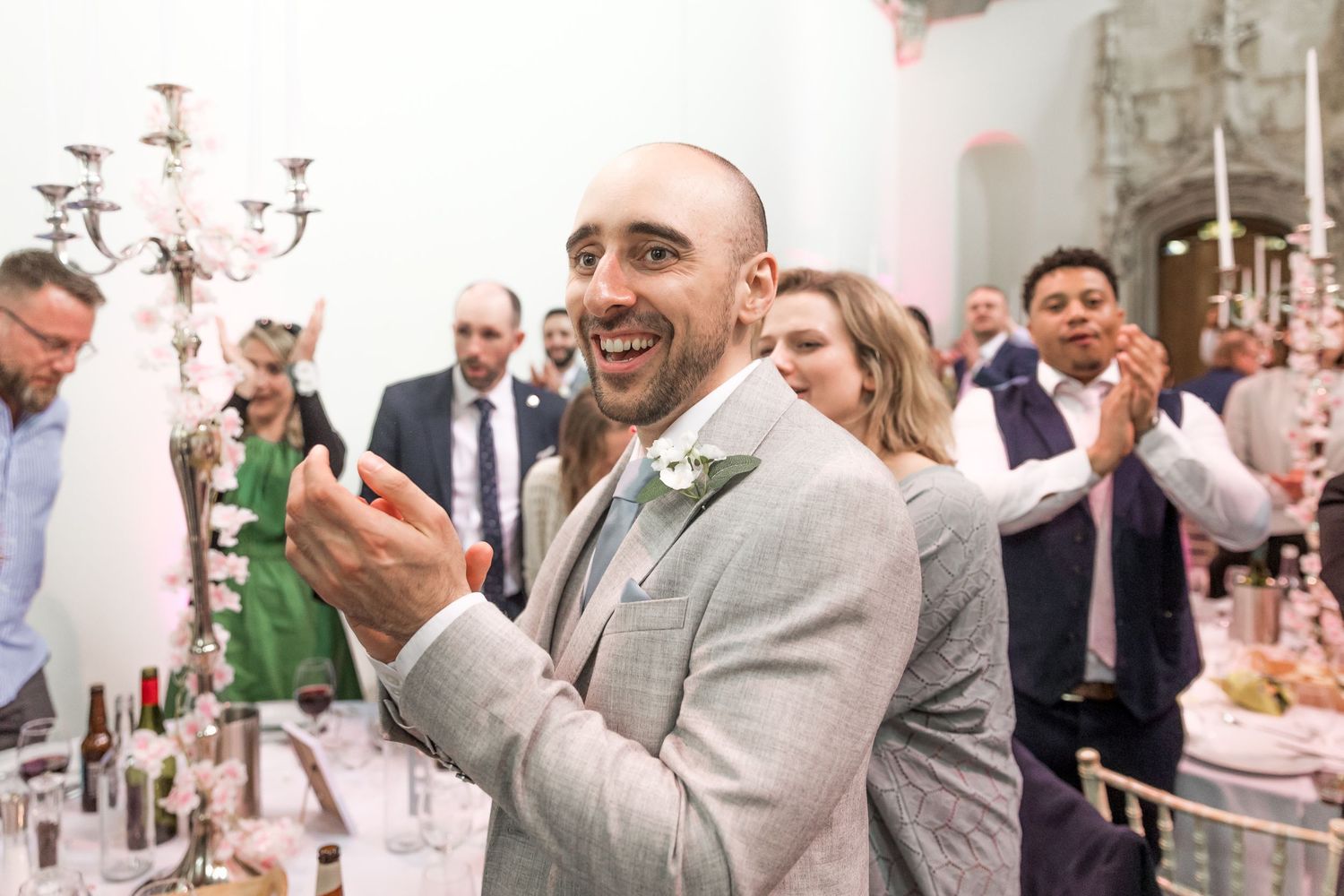 Wedding guests mingling and celebrating at an elegant indoor reception.