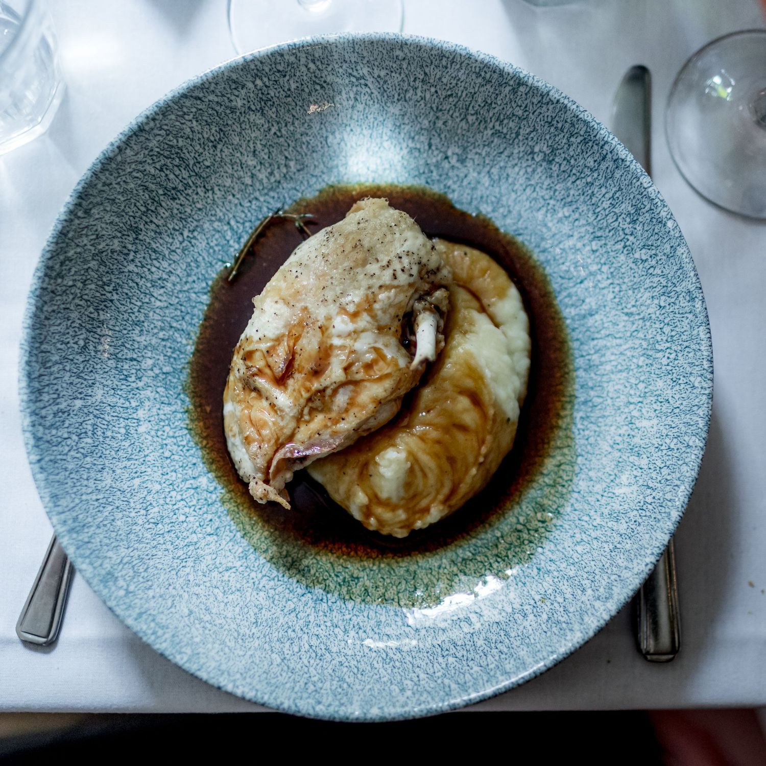 Series of plated dishes on textured blue ceramic plates with dark sauce.