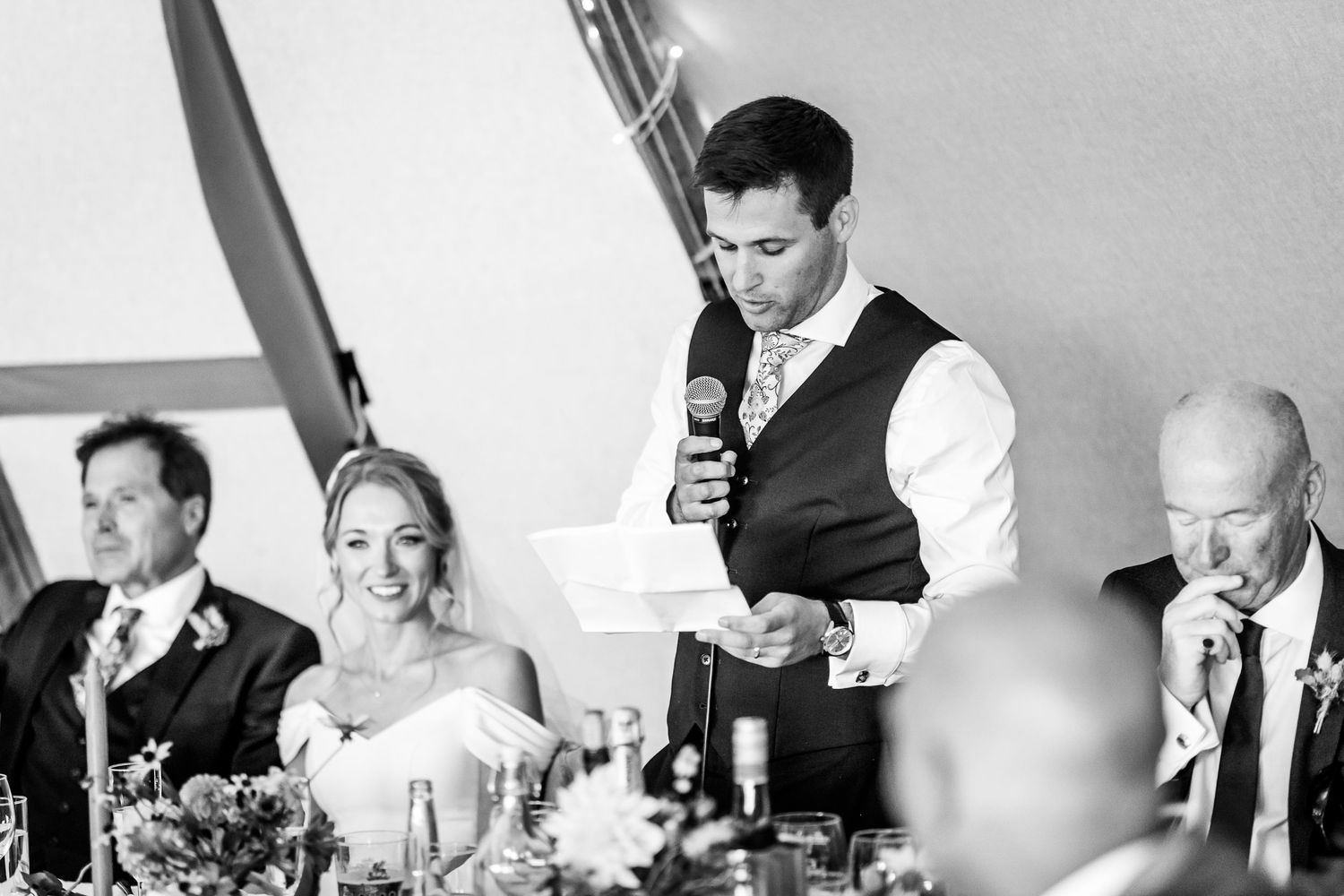 Black and white candid shots of wedding reception guests during speeches.